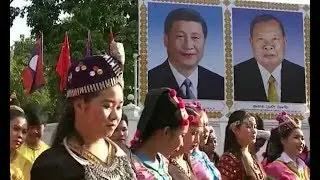 During visit, President Xi inks deals to assist development in Laos