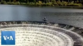 Fishermen Float Close to 'Plughole' on English Reservoir