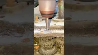 Enlarging Holes In A Metal Plate Using A Step Drill Bit Mounted On A Handheld Drill