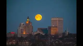 Timelapse Footage Shows Nearly Full Moon Dive Behind Providence Skyline