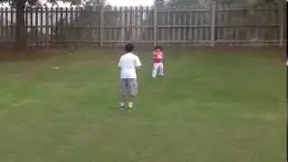 Caryn & Brandon are playing ball in the back yard