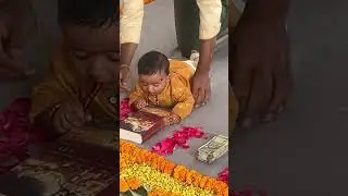 My baby boy&rsquo;s Annaprasana ceremony || money and Bhagavad gita book&pen