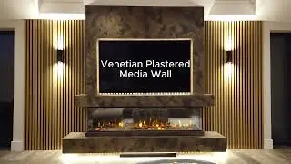 A Modern Media Wall Finished In A Textured Black & Bronze Venetian Plaster.