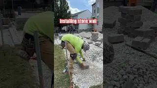 Installing stone wall to raised patio. #construction #unilock #outdoorliving #patio #pavers #foryou