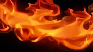 abstract background of orange smoke curves and wave isolated on black background