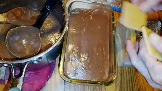 Making an icebox cake: layering hot  homemade chocolate pudding and graham crackers. Cool well 
