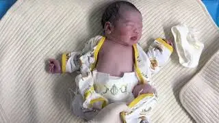 What is the experience of dressing a newborn baby?
