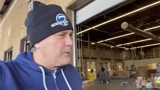 Lionel listens to Broncos fans while helping out at local food bank.