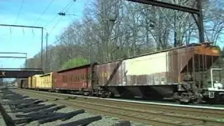 CSX 9022 leads CSX Q418-18 northbound at Woodbourne on April 18, 2009, and meets SEPTA Train 4153