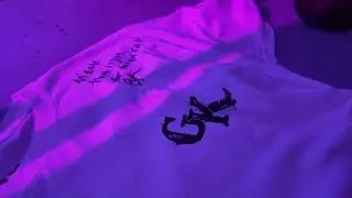 autographing a shirt for a fan
