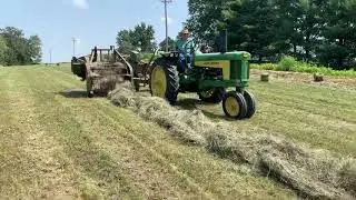 114 John Deere baler baling hay in Saline County Missouri