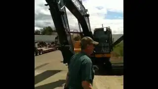John Deere 200D slipped off trailer upon delivery