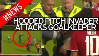 Horror moment goalkeeper is grabbed around throat by masked attacker who ran onto football pitch