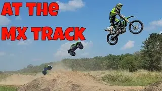 RC cars and dirt bikes at a motocross track - Rustler 4x4, Maxx, X-Maxx