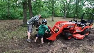 Using the Kubota tractor to pull out tree stumps