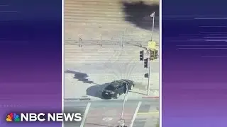 Man crashes into L.A. City Hall steps and barricades himself in car