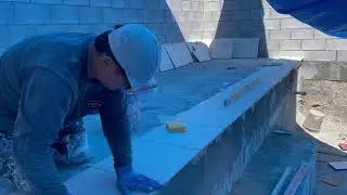 Rock wall and false infinity pool tiling during the rain