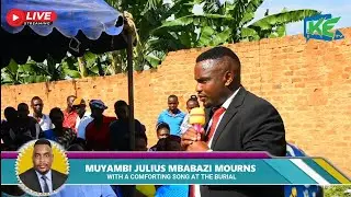 Muyambi Mbabazi Julius Mourns With a Comforting Song at the Burial