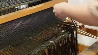 hand weaving - tying the warp threads for  good tension