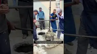 Six Workers Turn Lever Rings to Drive Manual Well Drilling