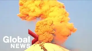 Dramatic eruption by Mexico's Popocatepetl volcano shimmers in morning sun