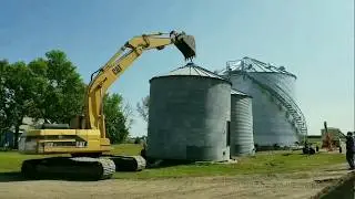 Moving grain bin with a backhoe, super cool!