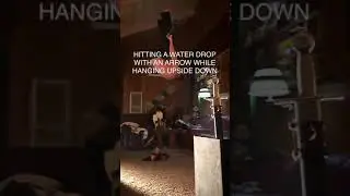 Guy Hangs Upside Down With Bow N Arrow and Hits Water Droplets - 1288127
