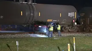 Body cam captures train dragging SUV with two trapped inside