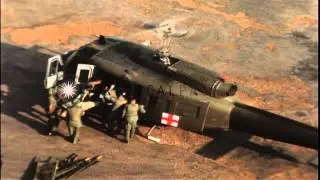 Wounded man on stretcher moved in MEDEVAC (Medical evacuation) helicopter by US s...HD Stock Footage