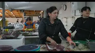 Batumi, Adjara, Georgia. - November 01, 2022: Georgian Woman Butchering Freshly Caught Fish On Local