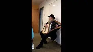 Rabi David Louis plays an ancient Jewish tune. on the harp.