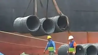 Steel exports from Russia. Cargo transshipment at the sea terminal. Seaport. Cargo ship. IEC.