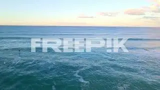 aerial view of surfers surfing in the blue ocean   water sport