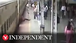 Shocking moment elderly man dragged underneath moving train