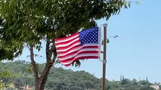 American Flag Flying in the Wind. God Bless The USA