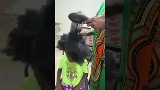 Straightening her hair getting ready for hair braid 