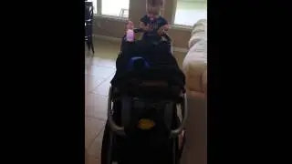 Baby girl pushing her stroller. ..