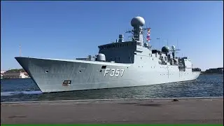 A Danish frigate leaving Aalborg harbor and heading to a fueling dock.