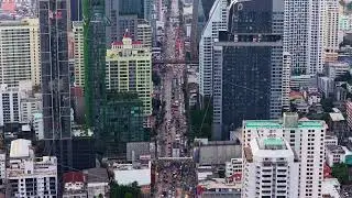 High angle tripod view of downtown Bangkok, Thailand, showing dense traffic moving along major road