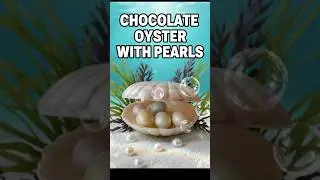 A chocolate shell with chocolate pearls inside.Шоколадная ракушка с  шоколадными жемчужинами внутри.