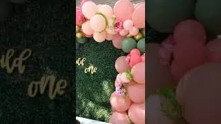 1st Birthday Party setup with grass backdrop, balloons & flowers by Classic Creation