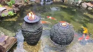 Aquascape urn & sphere fire feature added to theOlympian water gardens ecosystem koi pond