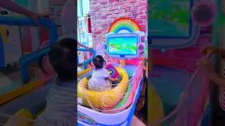 Siera Playing a Mini Boat Arcade ride
