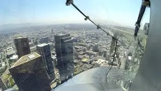 Riding down the OUE Skyspace LA Skyslide 1,000 feet above ground.