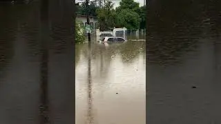 Heavy flood waters cover car in Mineral Heights, Clarendon Jamaica.