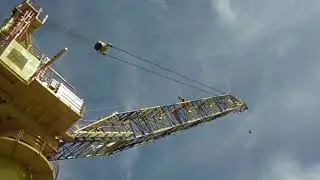 Material transfer from floating barge to production platform