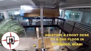 PROFESSIONAL MOVERS HOISTING A MASSIVE FRONT DESK TO A 2ND FLOOR IN WYNWOOD, MIAMI