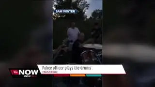 Police officer plays the drums
