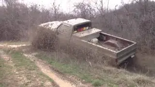 Massive Chev on 44's digging through deep mud hole