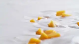 Tossing diced mango in yoghurt  Slow Motion Free Stock Videos Without Watermark